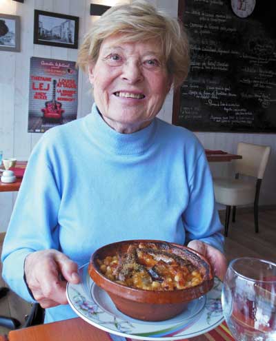 photo of a happy diner with her cassoulet