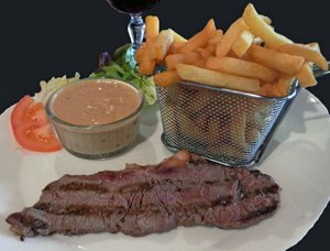 photo of grilled sirloin steak with fries